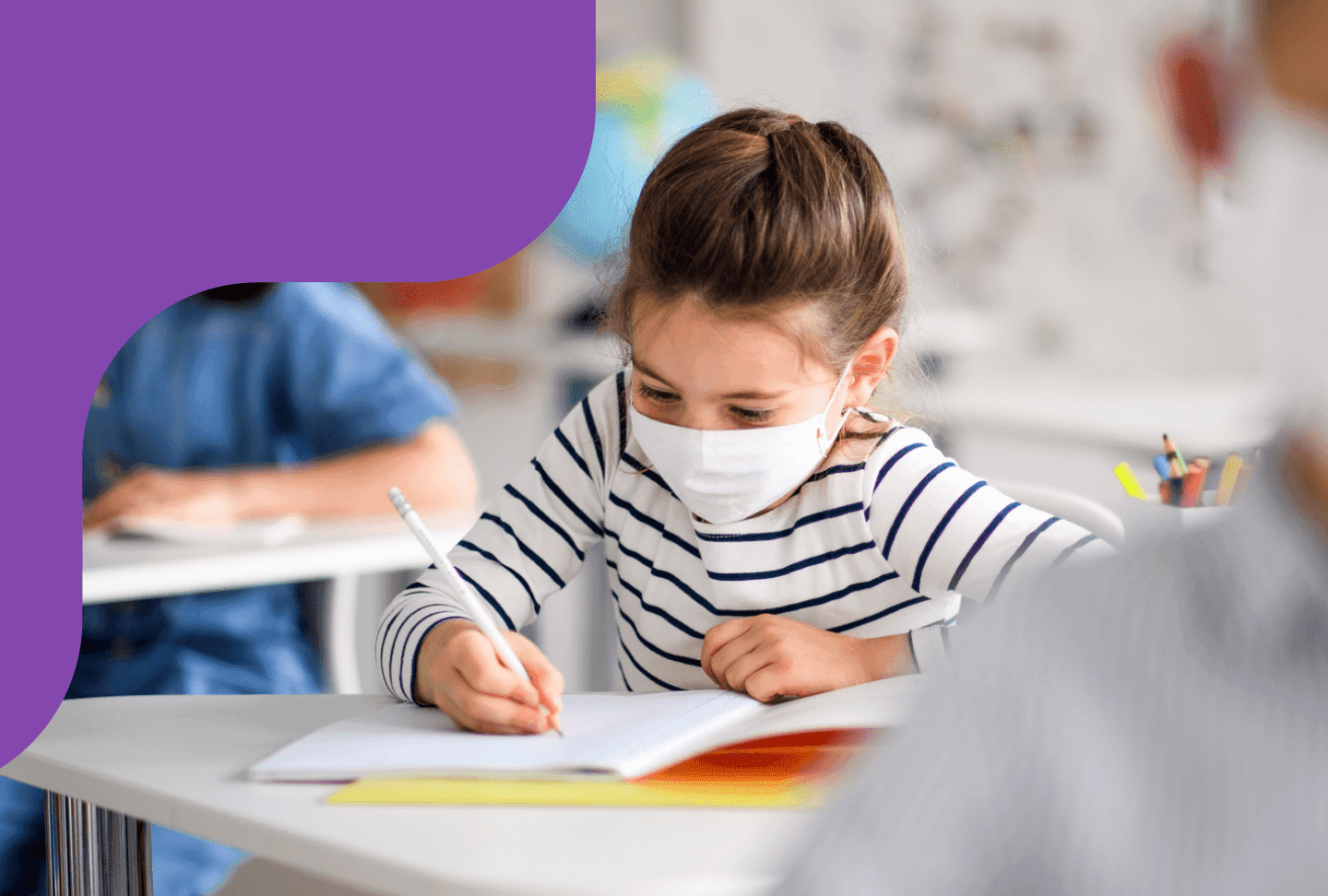 COVID-19: Back to School Girl using mask in the classroom.
