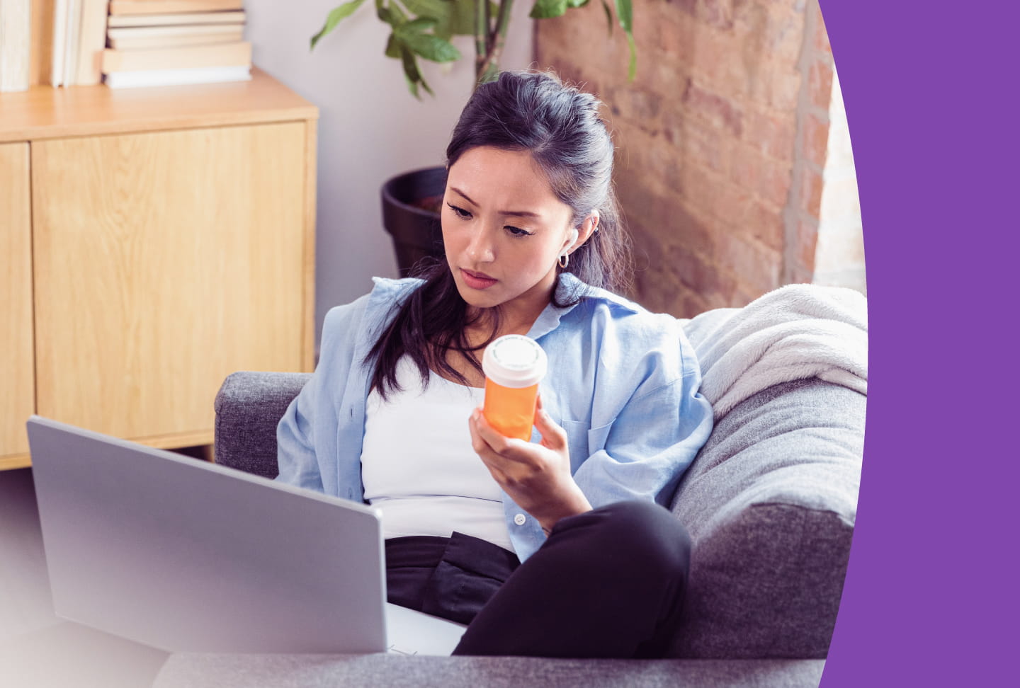 Keep Up With Your Prescriptions in Wellstar MyChart Person sitting with laptop, holding medication bottle