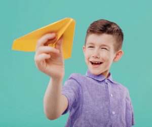 Image of child with paper airplane