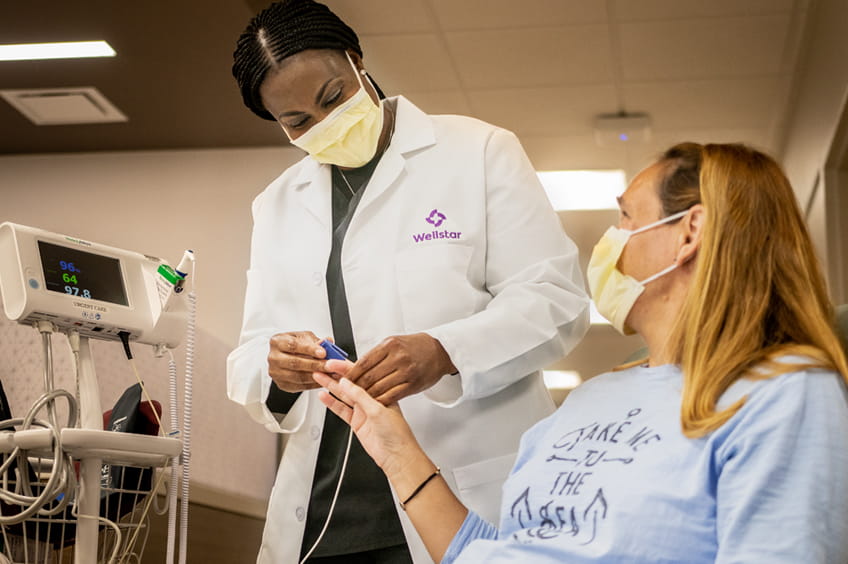 Wellstar doctor checks patient's blood pressure