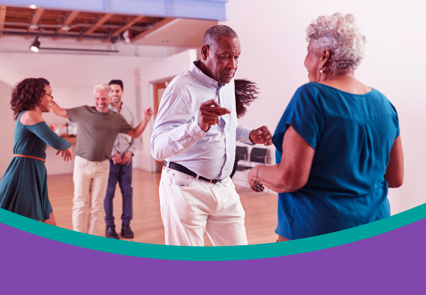 Image depicts people dancing in a ballroom style dance studio. 
