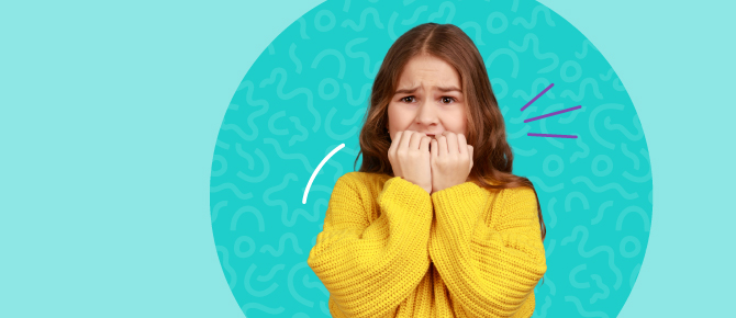 Elementary school aged girl bites fingernails and furrows her eyebrow. Parents and healthcare providers can help kids recognize and cope with feelings, stress, and anxiety.