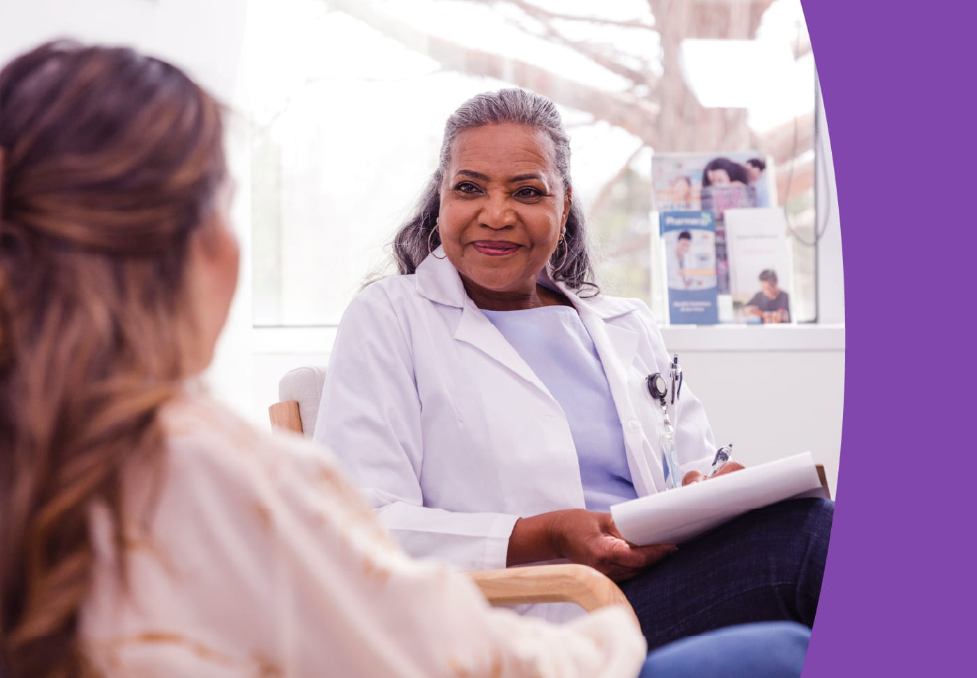 A healthcare professional listens carefully to her patient