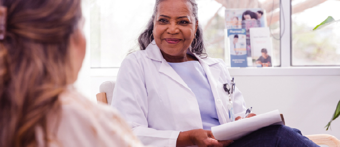 A healthcare professional listens carefully to her patient