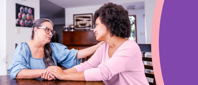 A woman consoles her friend as she shares difficult news.