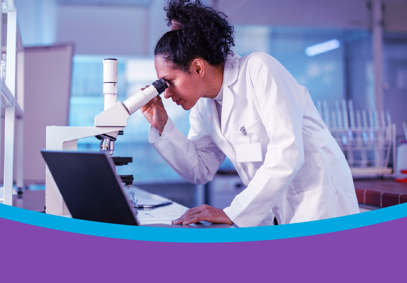 Clinician looking through microscope