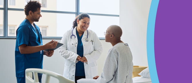 Healthcare providers consult with their patient at bedside