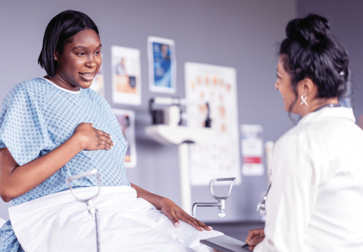 An OB/GYN healthcare provider reassures her patient during a medical examination