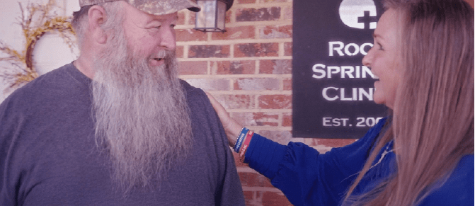 Two smiling people share a friendly conversation