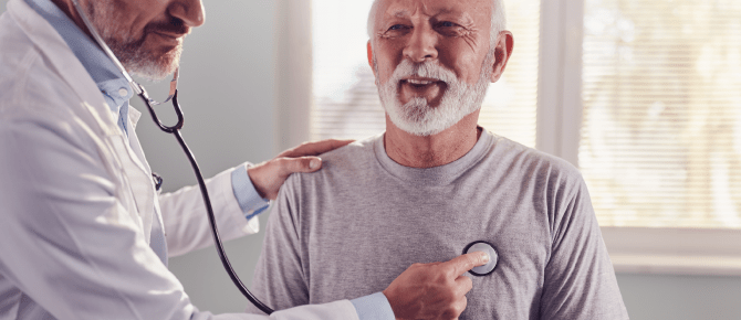 Healthcare provider checks the heart of his smiling patient with a stethoscope