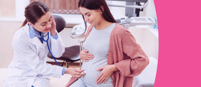 Healthcare provider listens to her pregnant patient's stomach area using a stethoscope