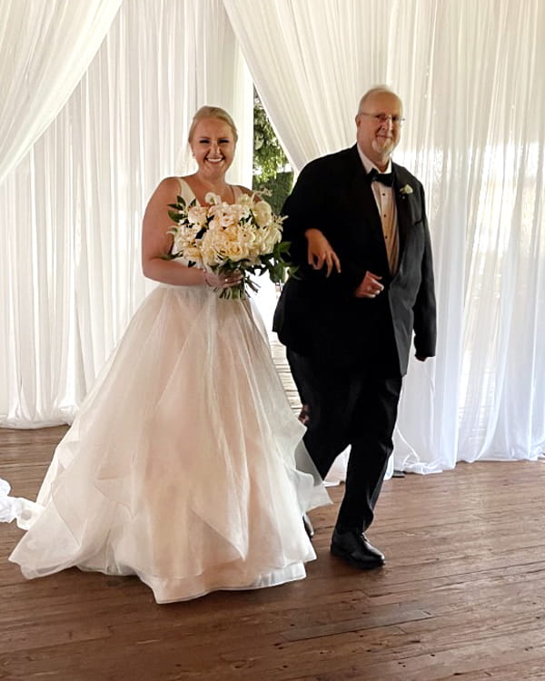 Patient Mike Clements walking his daughter down the aisle at her wedding