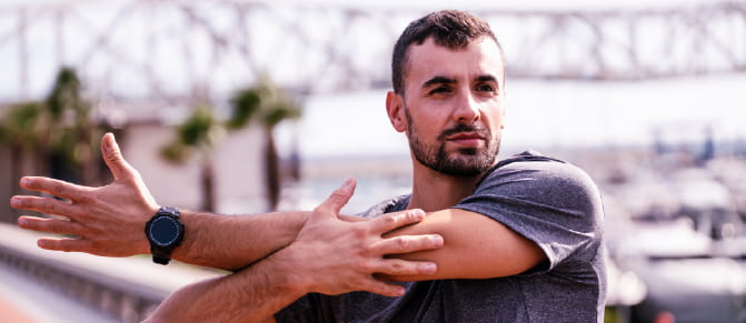 Man exercising his upper body by stretching his arm