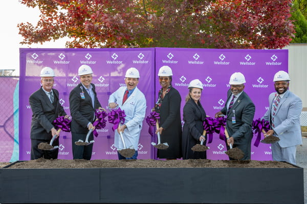 Hospital leaders hosted a ceremonial groundbreaking on a major expansion of Wellstar Radiation Oncology at Wellstar Paulding Medical Center. Here, a group holds shovels and wear hard hats at the site of construction.