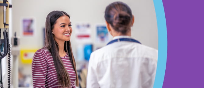 Healthcare provider consults with her young adult patient