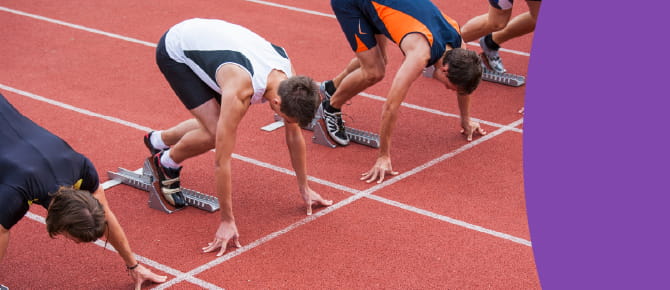 Runners take their mark on the track.