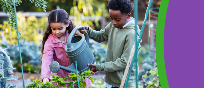 Two children water plants in a garden