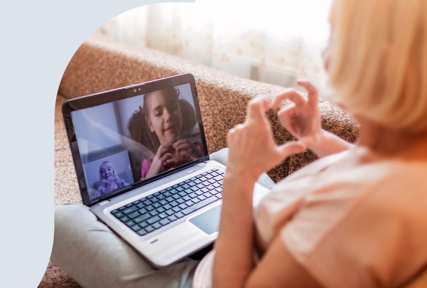 Grandmother video chatting with granddaughter.