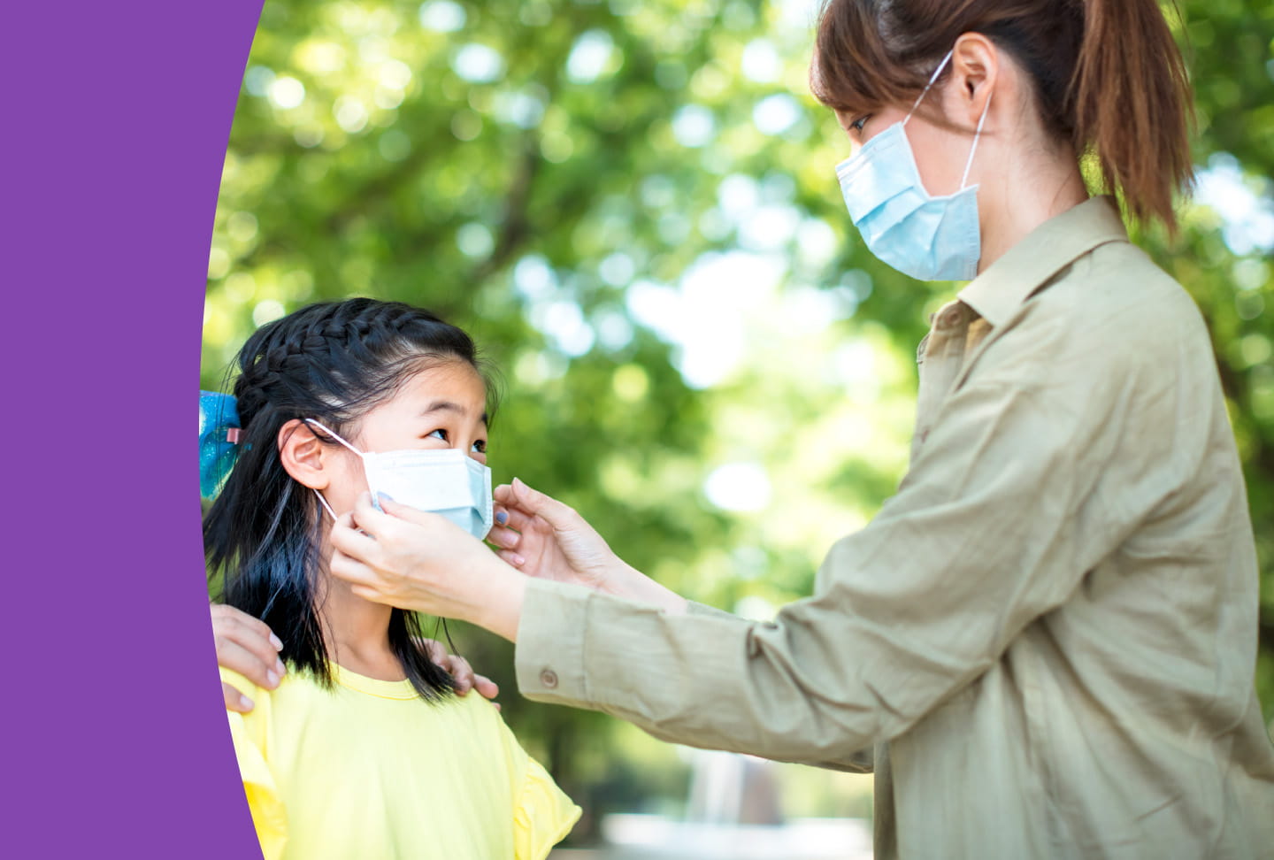 Mom helping daughter with mask.