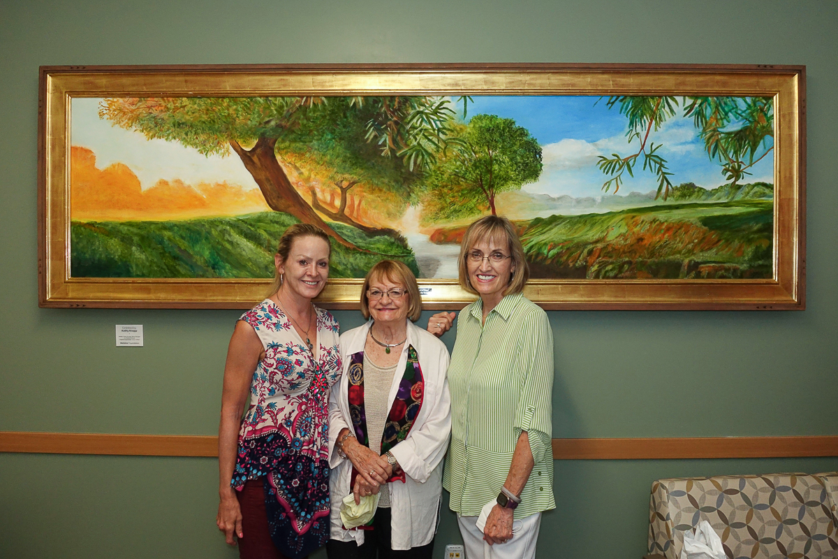 Three people with painting