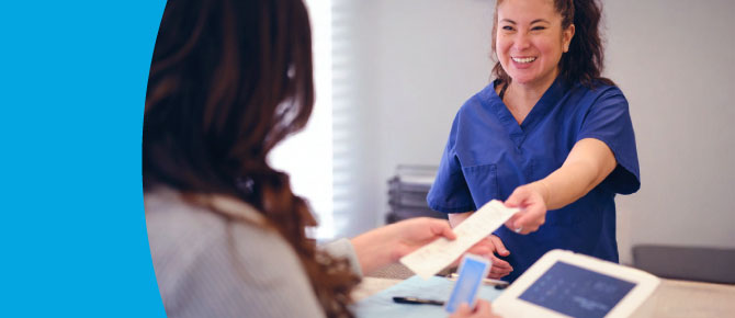 Image of woman paying medical bill