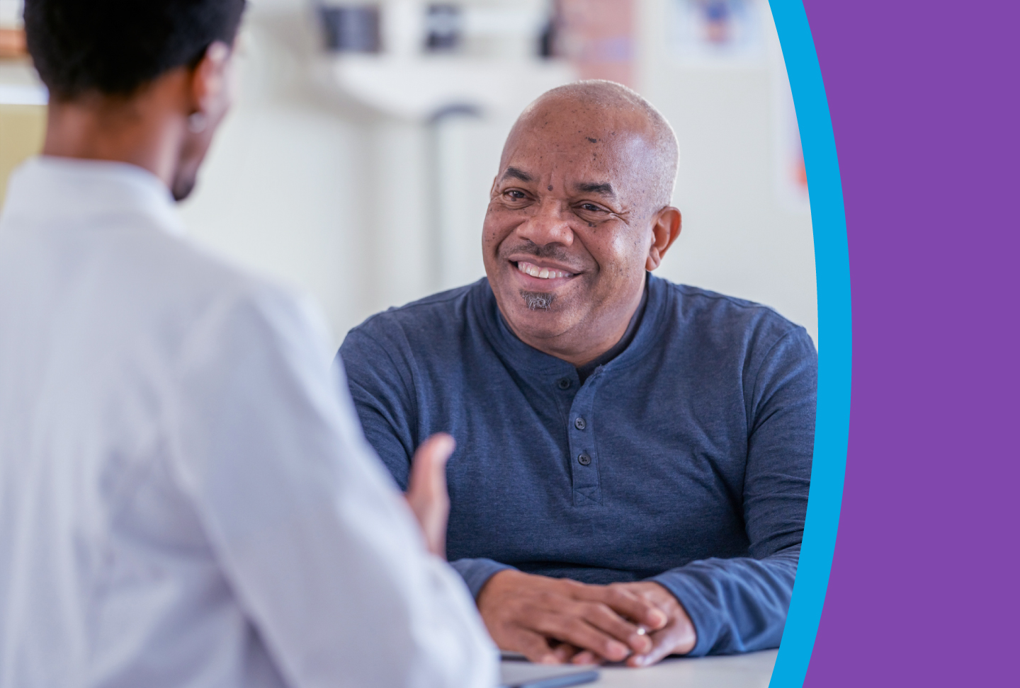 A healthcare provider explains options to a smiling man