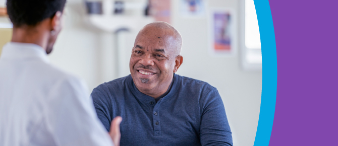 A healthcare provider explains options to a smiling man