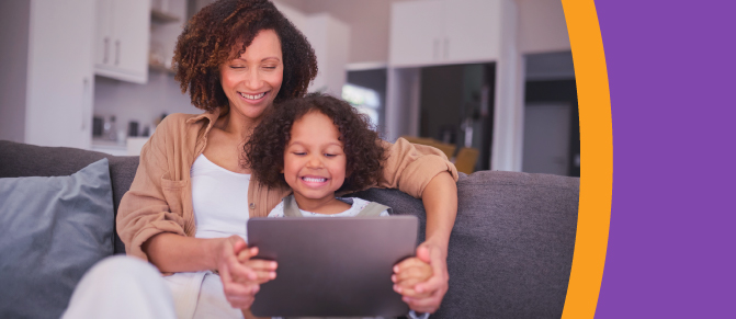 A parent and young child look at a tablet together.