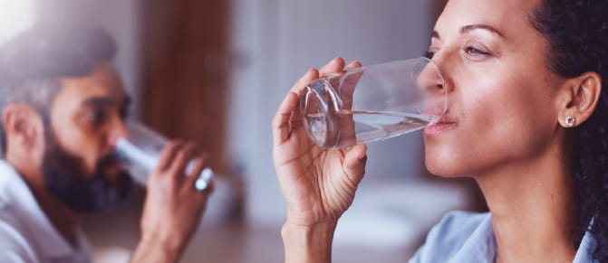 Woman and man drinking water