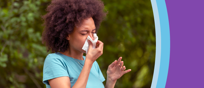 An allergy sufferer blows her nose