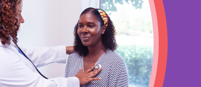 A healthcare provider listens to her patient's heartbeat.