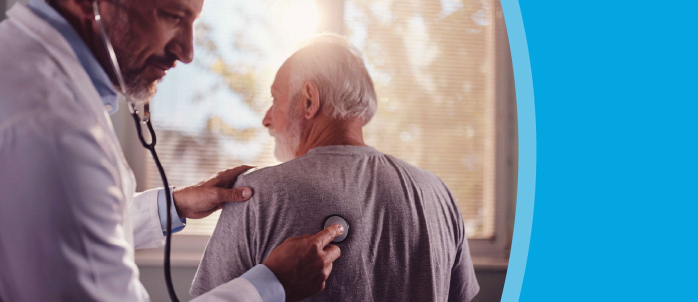 Healthcare provider listens to his patient's lungs using a stethoscope