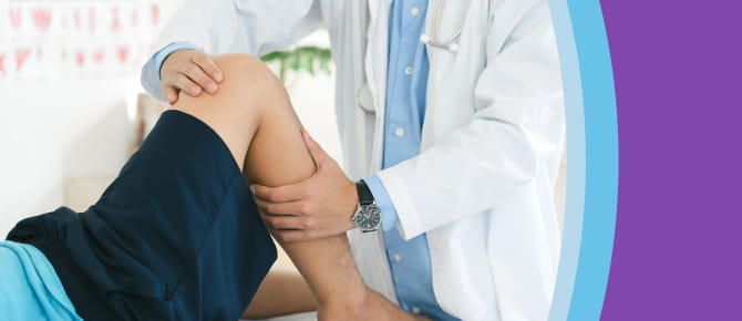 Orthopedic healthcare provider examines his patient's leg and knee