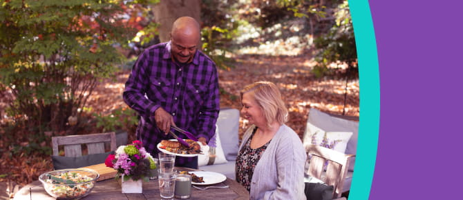 People at table outside serving food