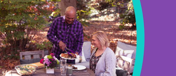 People at table outside serving food