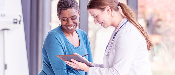 Provider speaking with patient. Text reads "Make health your habit"