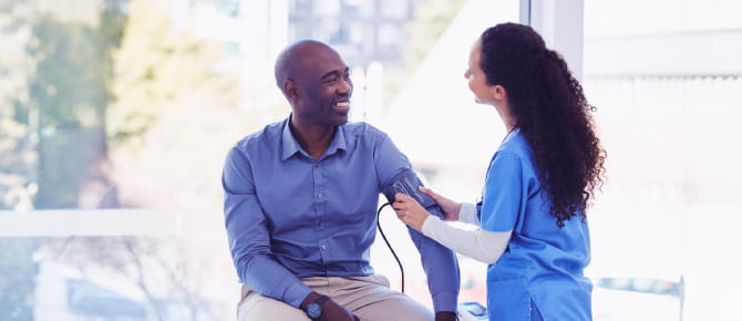 Provider checking patient's blood pressure