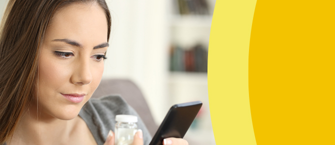 Woman looking up medications on her phone.