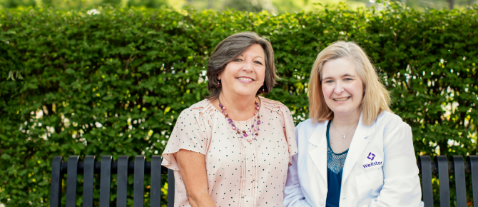Sandy and Kellie sitting on a bench.