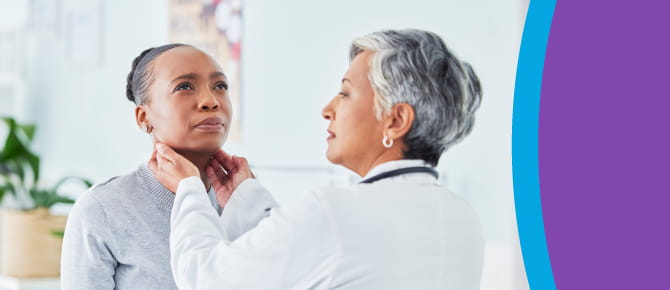 Female Wellstar head and neck cancer physician performs physical exam of female patient's neck area.