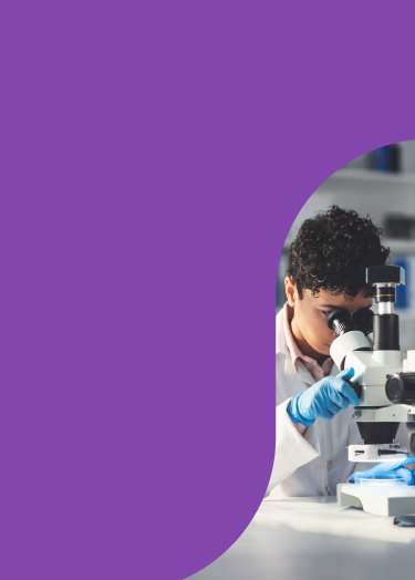 Image of scientist looking through microscope