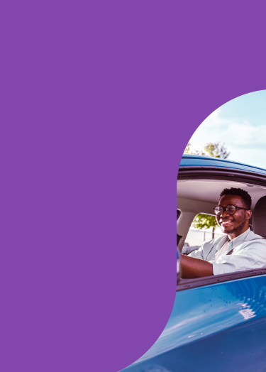 Wellstar epilepsy care image shows young Black man smiling as he safely drives a car.
