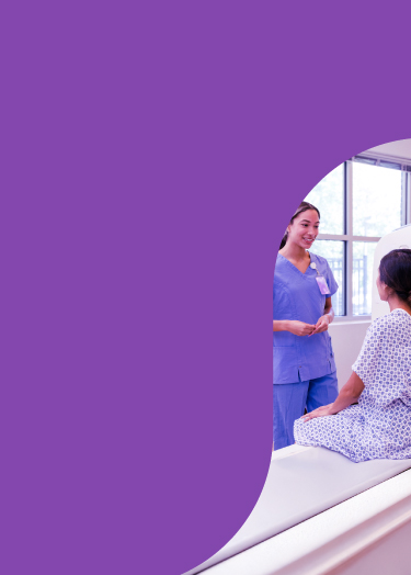 Smiling healthcare provider speaks with her patient