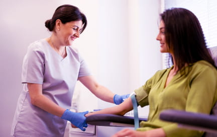 Healthcare provider prepping her patient for a blood draw