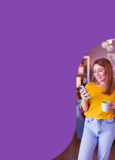 Young woman smiles while looking at her smartphone