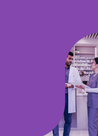 Image of pharmacist talking with assistant