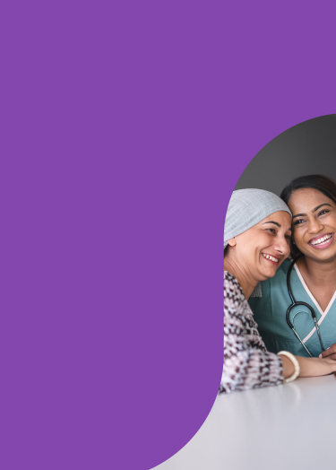 Photo of medical professional hugging a cancer patient.