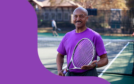 Ulysses Price holding a tennis racquet.