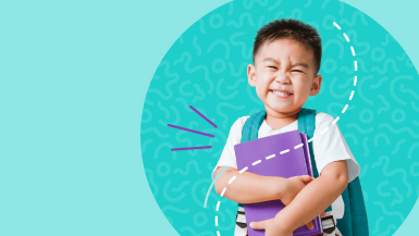 Smiling boy wearing a backpack and holding school books