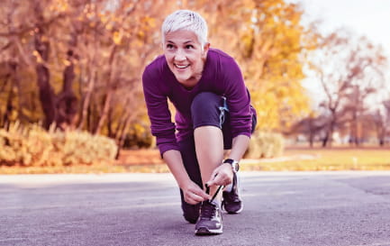 Woman tying the laces on her running shoes